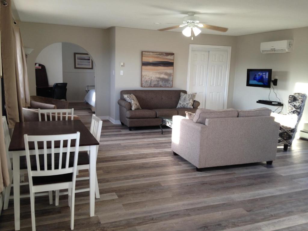 a living room with a couch and a table at Middleton Motel & Suites in Middleton