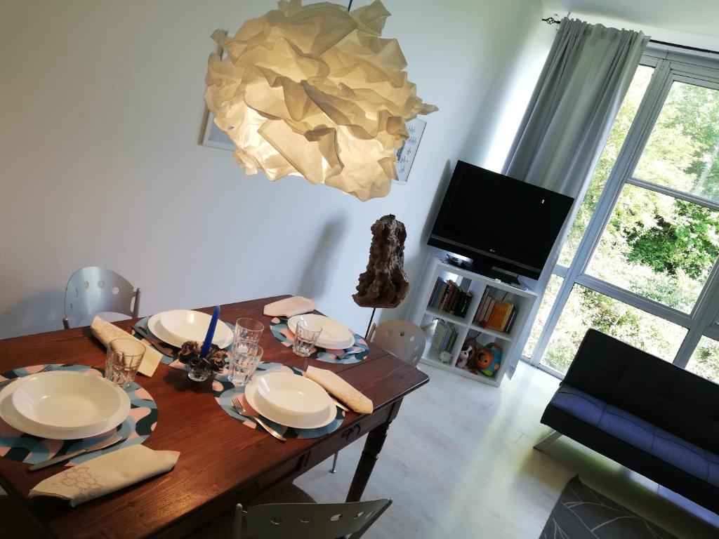 a dining room with a wooden table and a television at Appartamento Lettera 22 in Ivrea