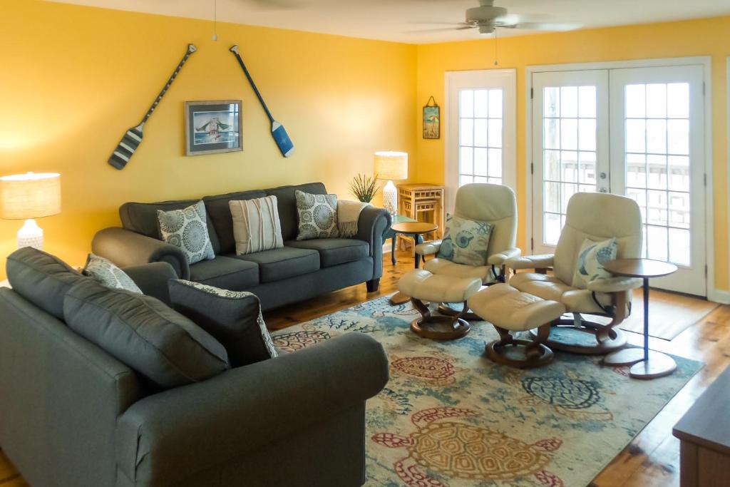 a living room with a couch and chairs at Two Views in Dauphin Island