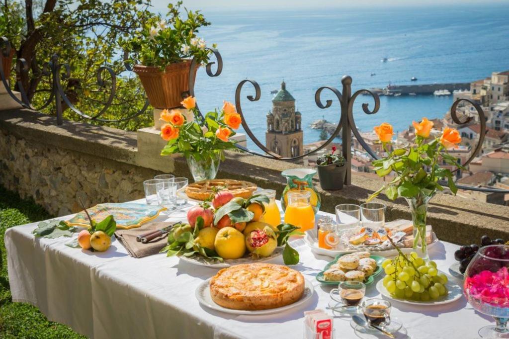a table with food on it with a view of the ocean at O'Lattariello in Amalfi