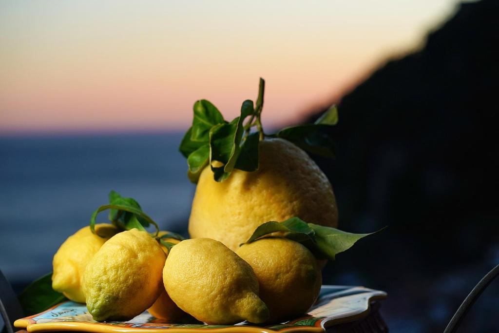 a pile of lemons sitting on top of a plate at O' Lattariello in Amalfi