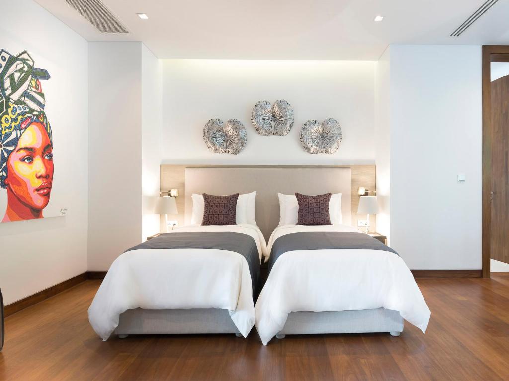 Ein Bett oder Betten in einem Zimmer der Unterkunft Malaiwana Residences