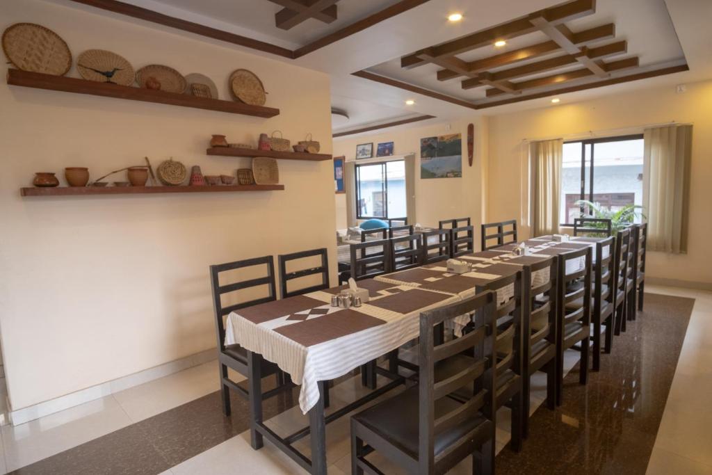 a long dining room with a long table and chairs at Hotel Sublime in Pokhara