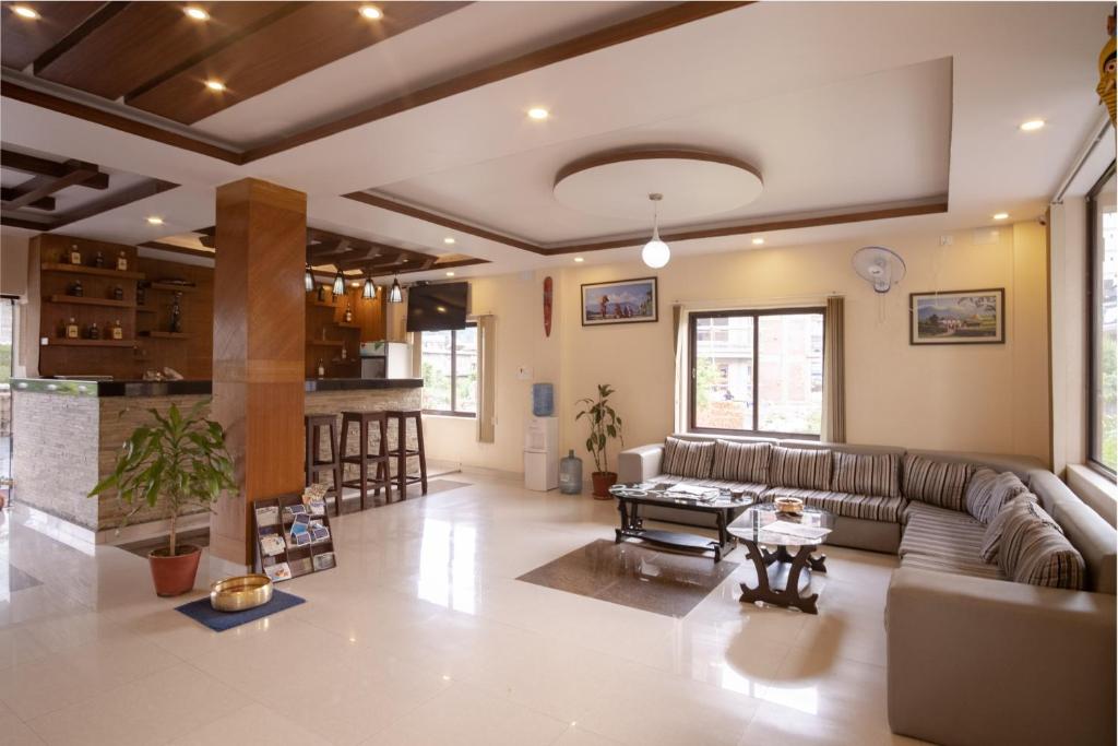a living room with a couch and a table at Hotel Sublime in Pokhara