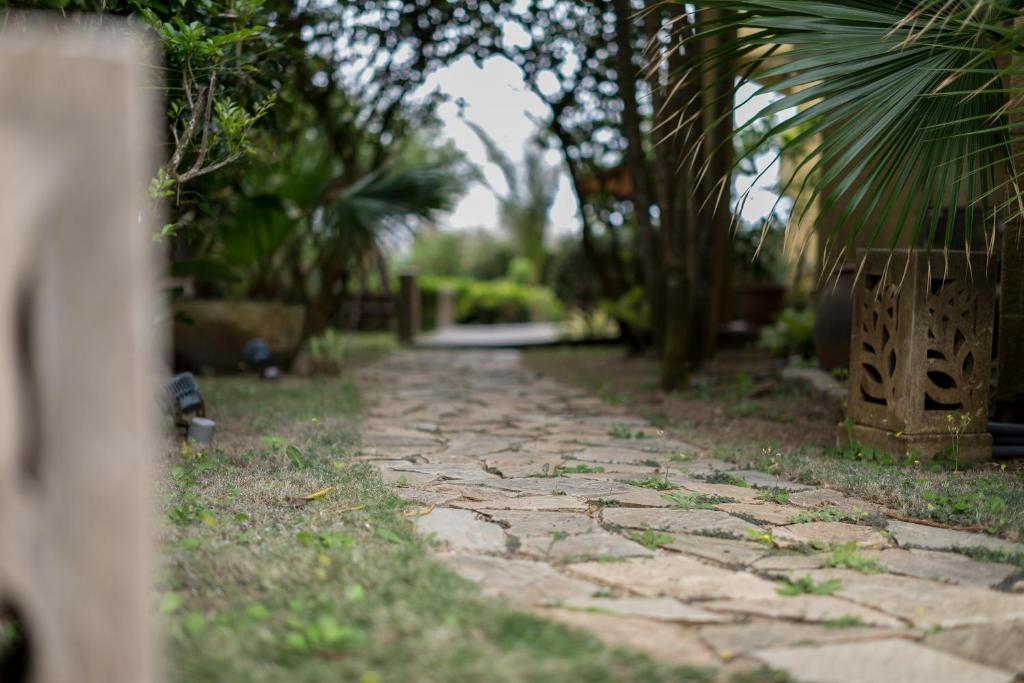 a stone walkway in a yard with trees at Be my house in Magong