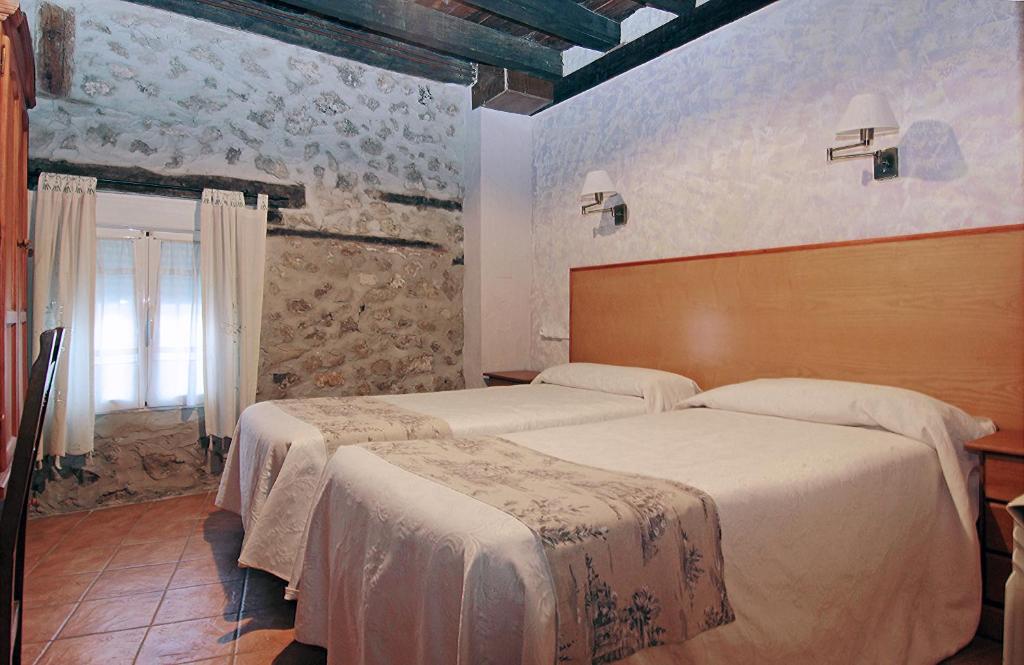 A bed or beds in a room at HOTEL RURAL LOS ABUELOS
