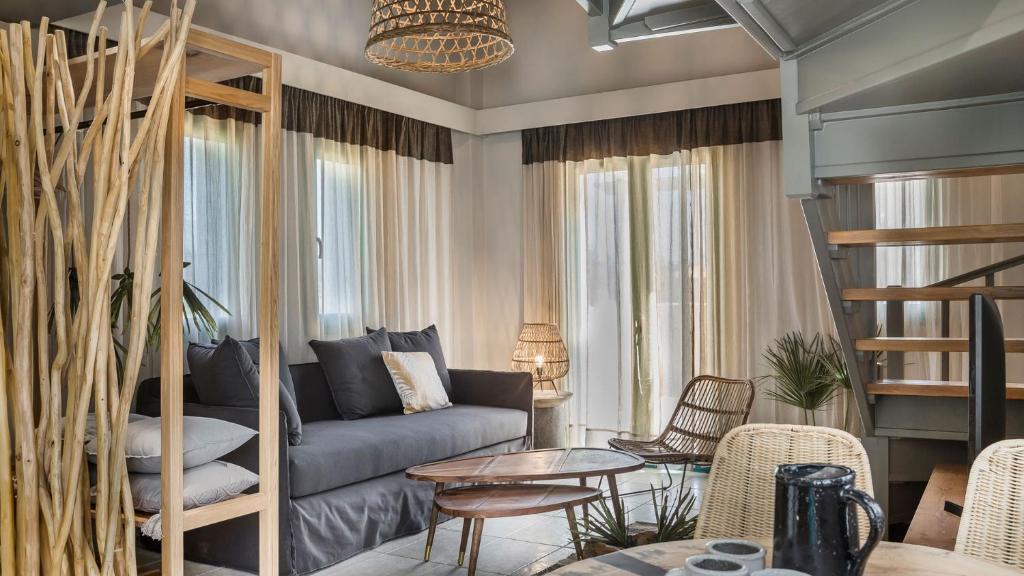 a living room with a couch and a bunk bed at Avithos Resort Hotel in Svoronata