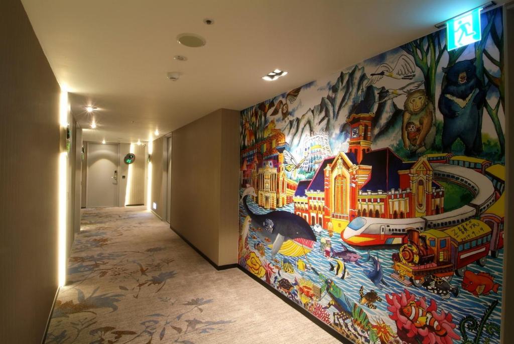 a hallway with a large painting on the wall at The Cloud Hotel in Taichung