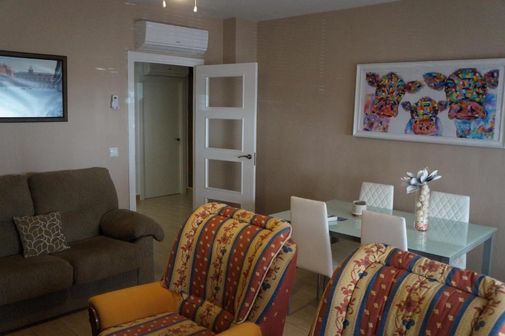 a living room with a couch and a table and chairs at Apartamento Salvador 37 in Almagro