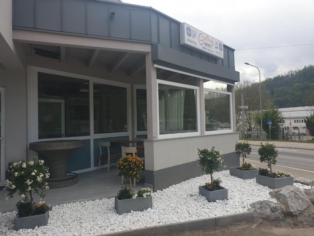 a building with potted plants in front of it at Gasthof Niki in Kapfenberg