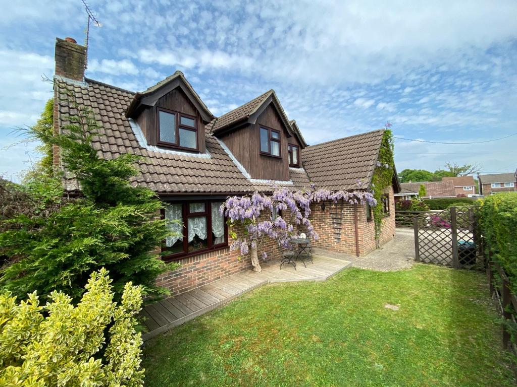 Una casa de ladrillo con una corona de coronas púrpuras. en Stunning Rustic Home, New Forest National Park en Southampton