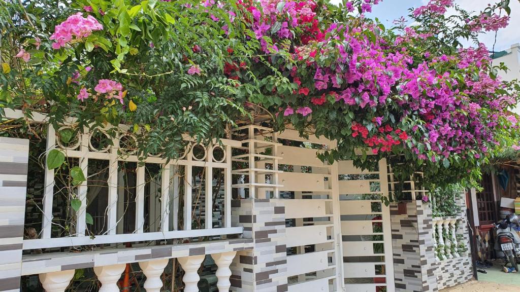 a white fence with flowers on top of it at Mina Thien Ha in Da Lat