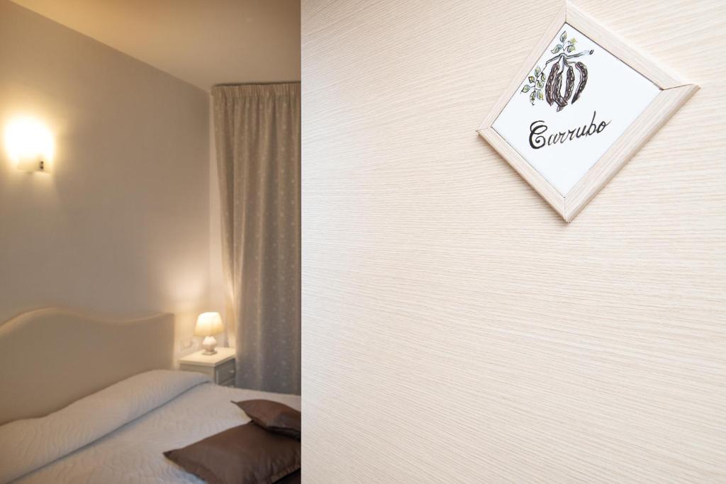 a bedroom with a bed and a sign on a wall at O' Lattariello in Amalfi