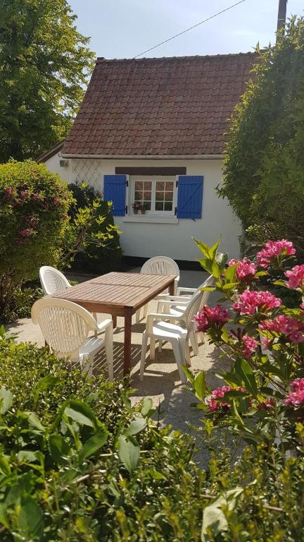 - une table de pique-nique et des chaises en face d'une maison dans l'établissement Apart - Country at Tingry, à Tingry