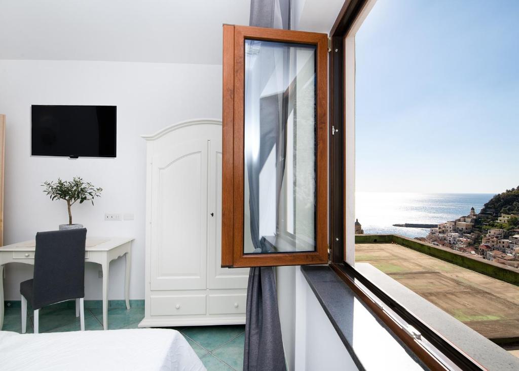 a room with a window with a view of the ocean at O' Lattariello in Amalfi