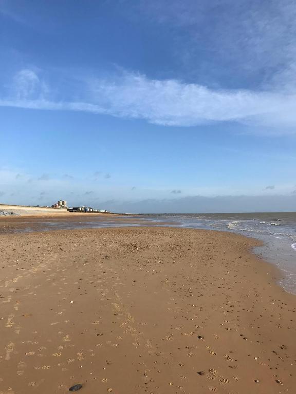 an empty beach with footprints in the sand at Frinton Escapes in Frinton-on-Sea