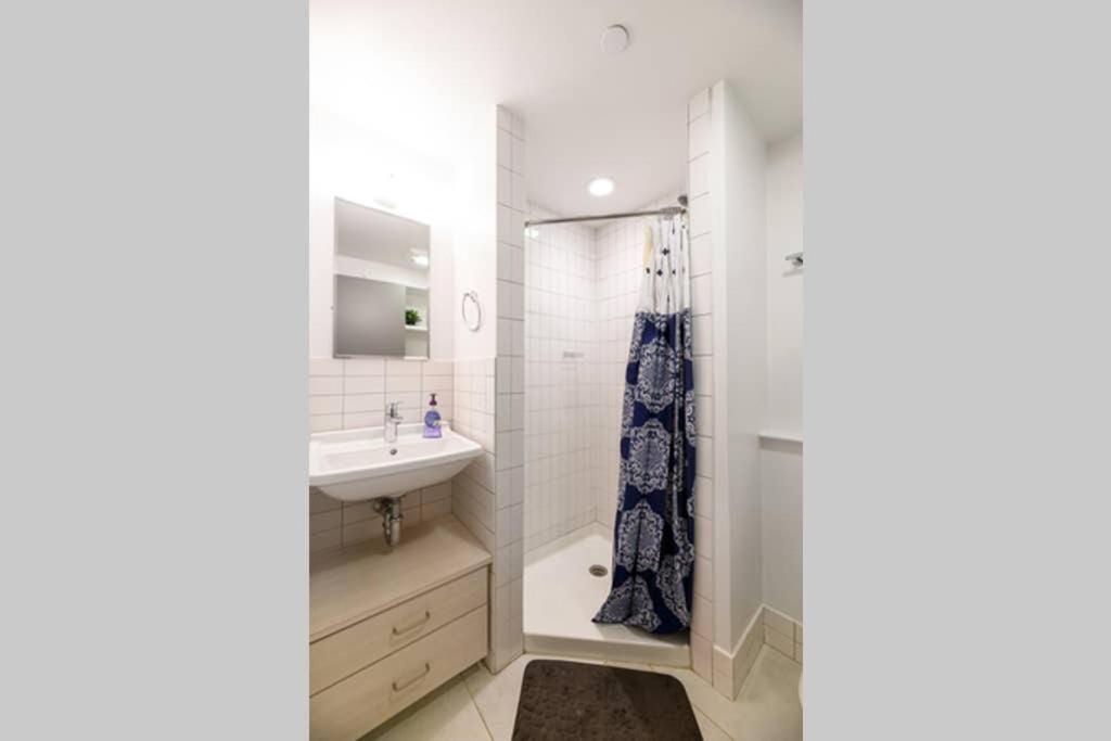 a bathroom with a sink and a shower at Modern Studio In City Center, Near Boston Common in Boston