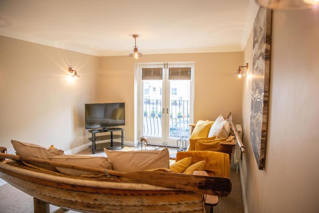 a living room with a wooden boat on the floor at The Beach House in Eastbourne