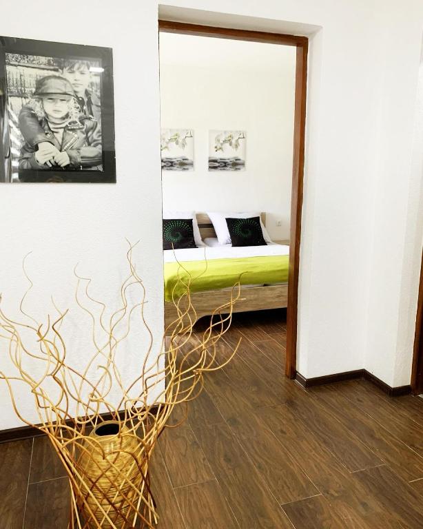 a room with a bedroom with a bed and a mirror at Modern Apartment 2 in Brčko