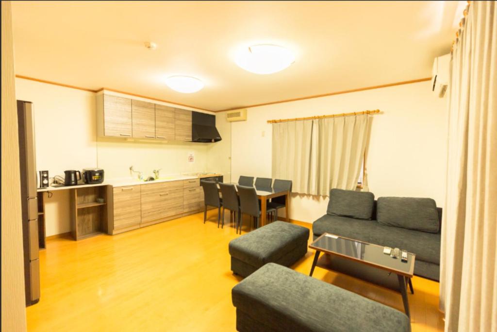 a living room with a couch and a table at Fukuoka - House / Vacation STAY 81254 in Fukuoka