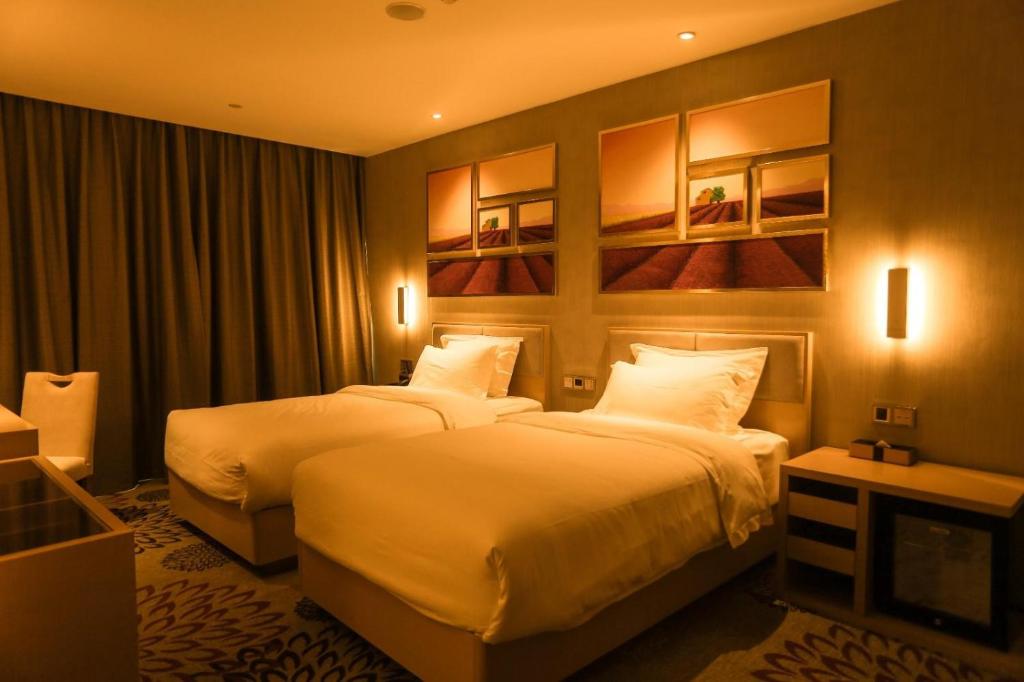 Ένα ή περισσότερα κρεβάτια σε δωμάτιο στο Lavande Hotel Xiangyang Train Station Peoples Square