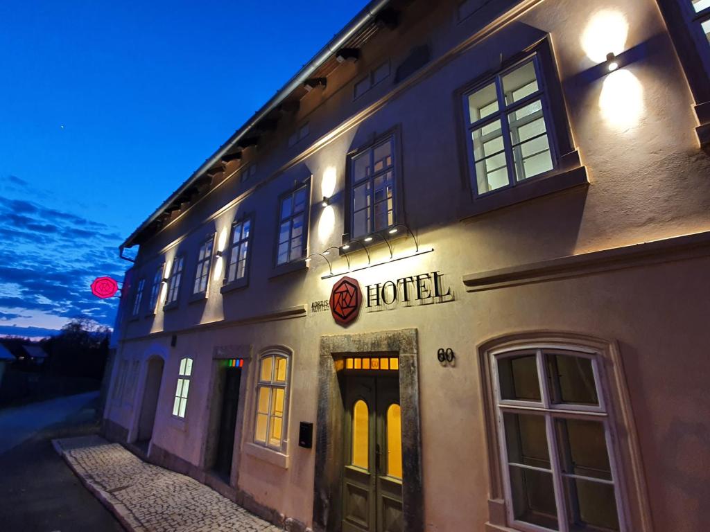 a hotel sign on the side of a building at Hotel KORTUS in Jetřichovice