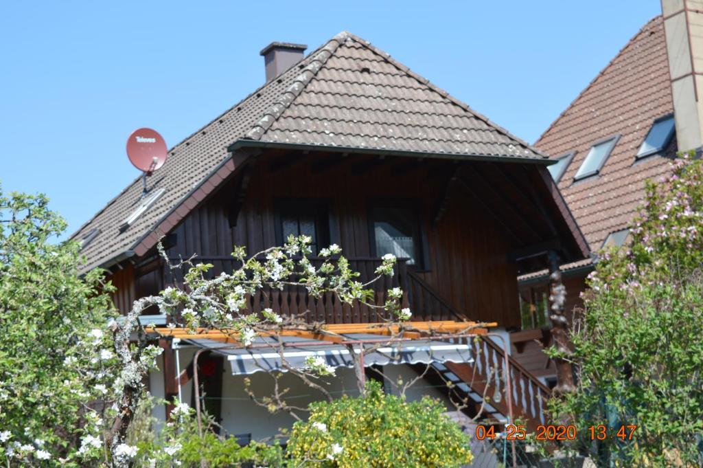 a house with a balcony and a roof at Ferienwohnung Beim Holzmann in Gutach