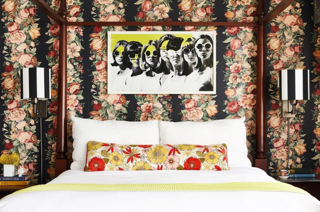 a bedroom with a bed with floral wallpaper at White Swan Inn in San Francisco