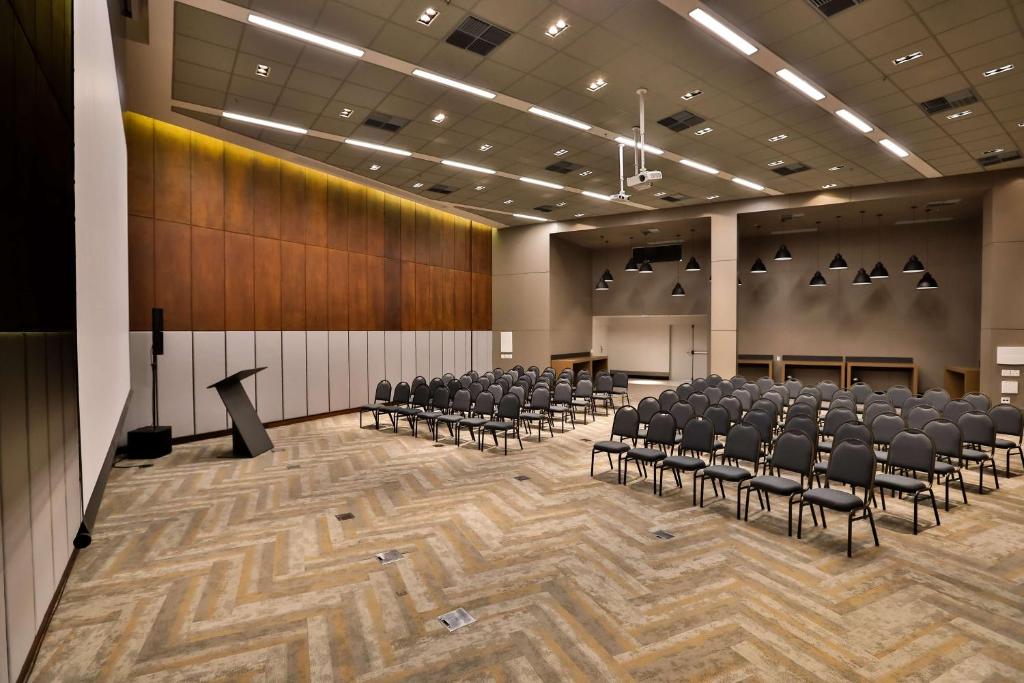 a large room with chairs and a podium in it at Radisson Vila Olimpia Sao Paulo in Sao Paulo