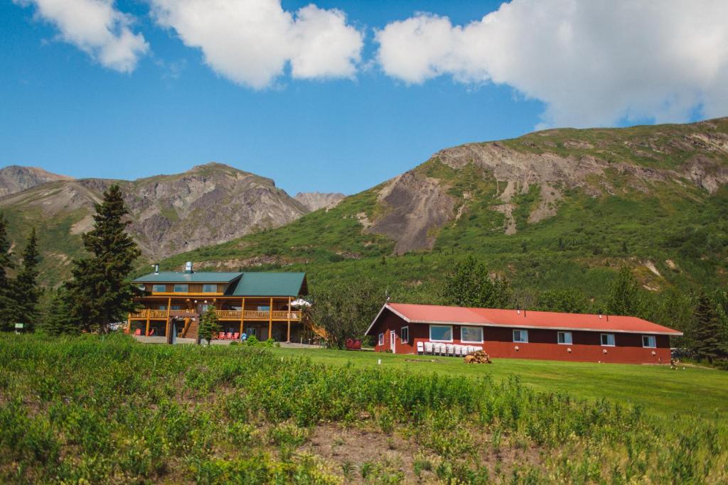 a large red building in front of a mountain at Majestic Valley Wilderness Lodge in Sutton