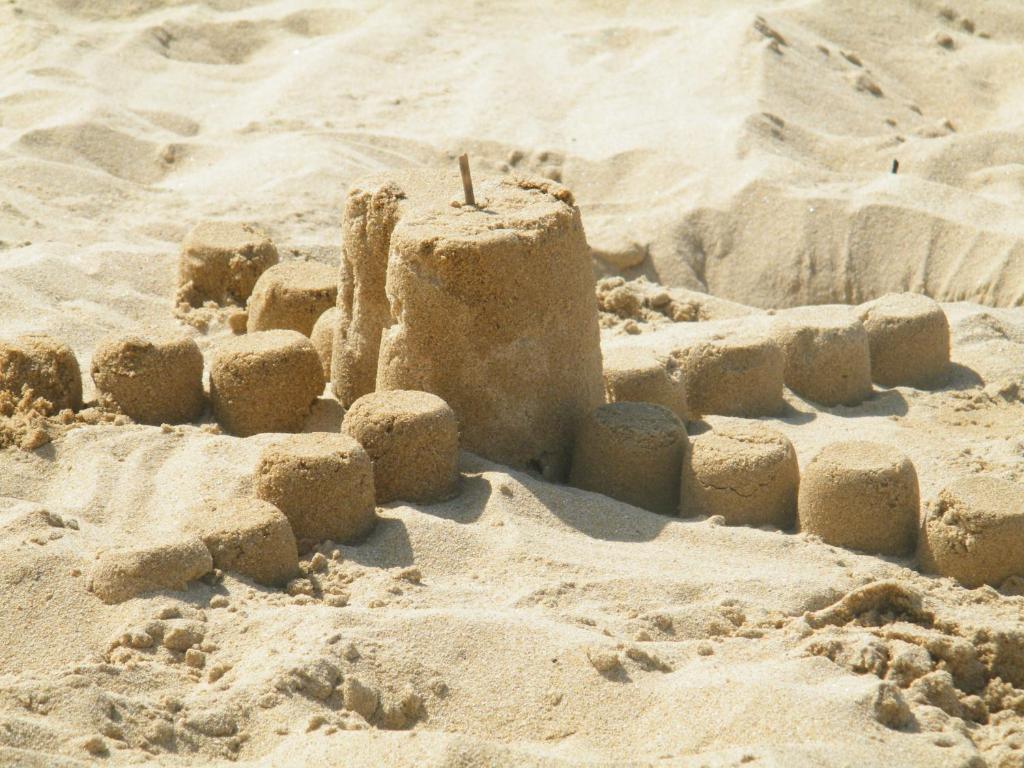 a sand castle in the sand on a beach at Fun Family Home - Camping Les Charmettes in Les Mathes