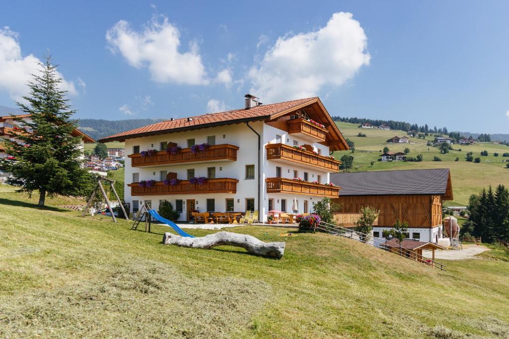 a large house on a hill with a playground at Residence Speckerhof in Maranza