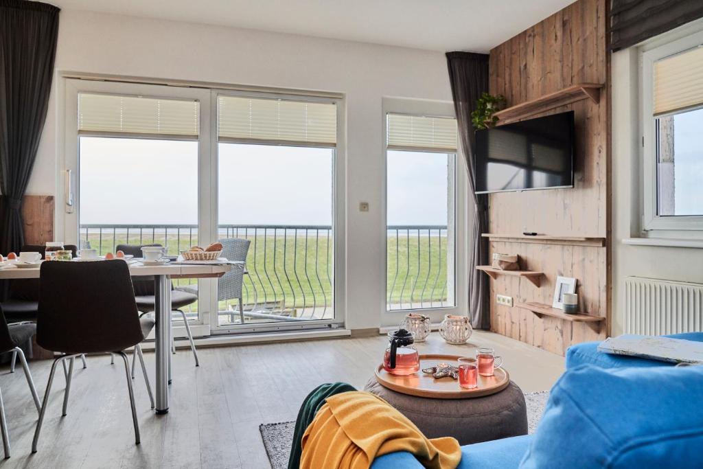 a living room with a view of the ocean at Haus Pamir _ Fewo 25 in Cuxhaven