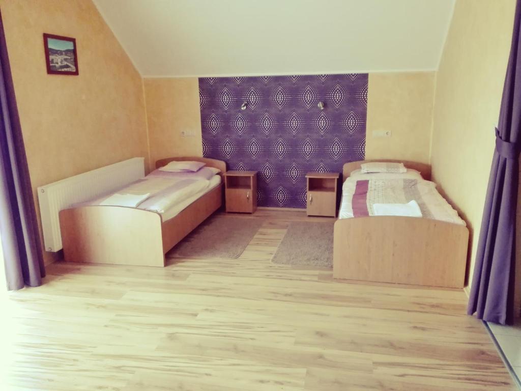 Postel nebo postele na pokoji v ubytování Főnix Apartmanház