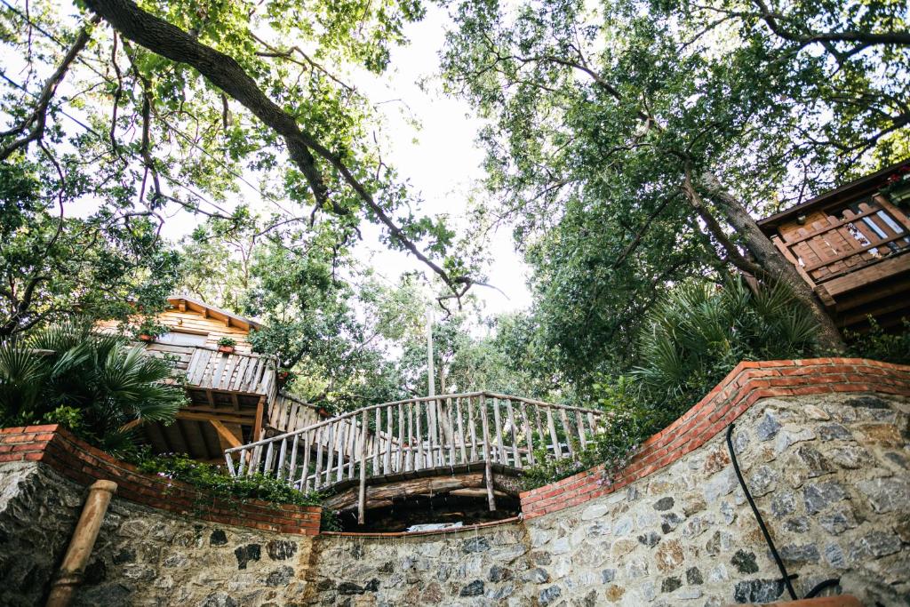 a staircase leading up to a house in a forest at B & B Le Casette sull'albero di Villa Alba in Messina