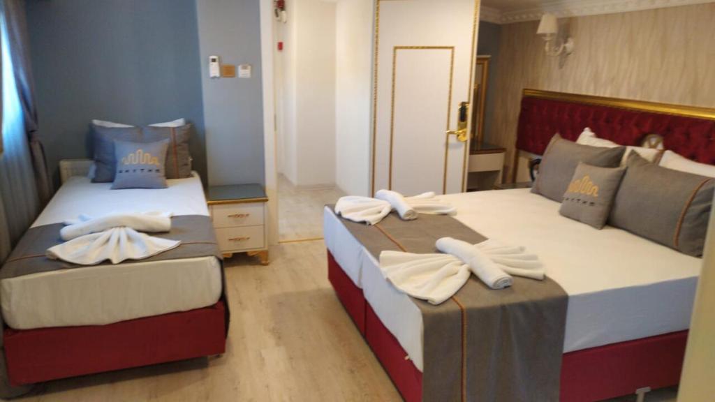 מיטה או מיטות בחדר ב-RHYTHM HOTEL