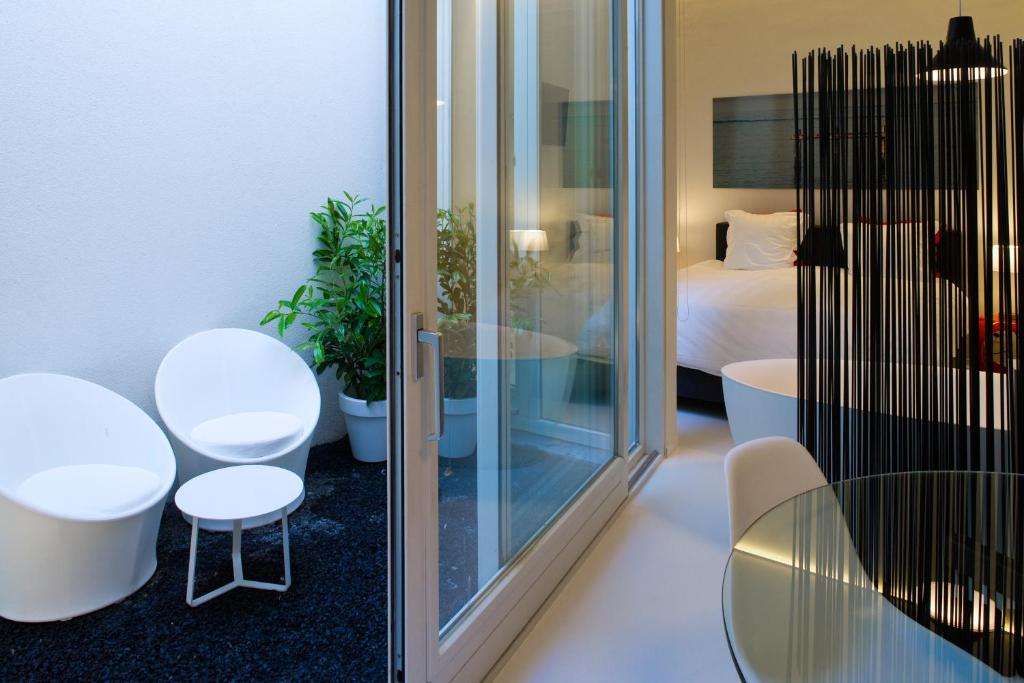 Cette chambre comprend une table, des chaises et un lit. dans l'établissement Leopold5 Luxe-Design Apartment, à Ostende