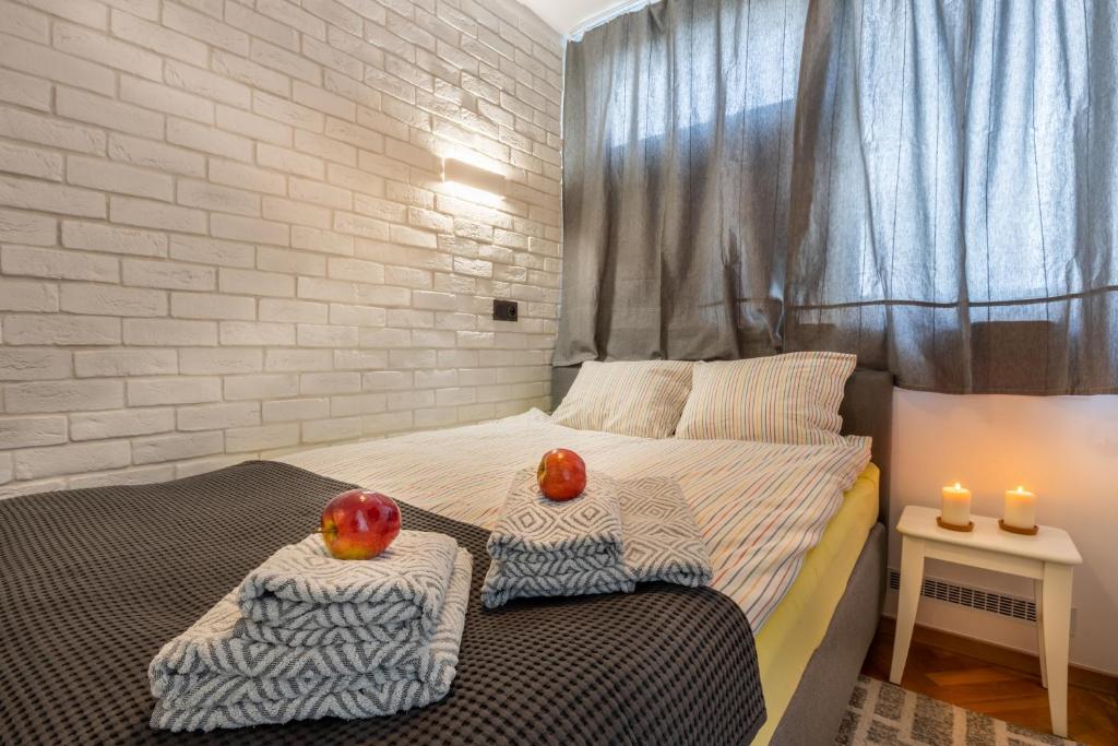 a bedroom with a bed with two apples on it at Apartment Strict Warsaw Center - Metro, Free Parking in Warsaw
