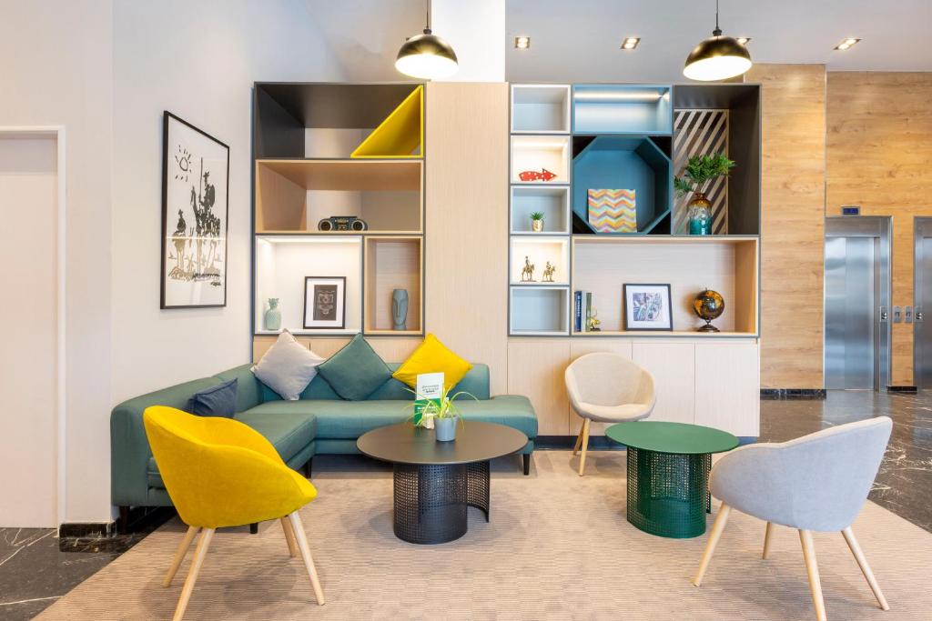 a living room with a couch and chairs and a table at Holiday Inn Madrid - Las Tablas, an IHG Hotel in Madrid