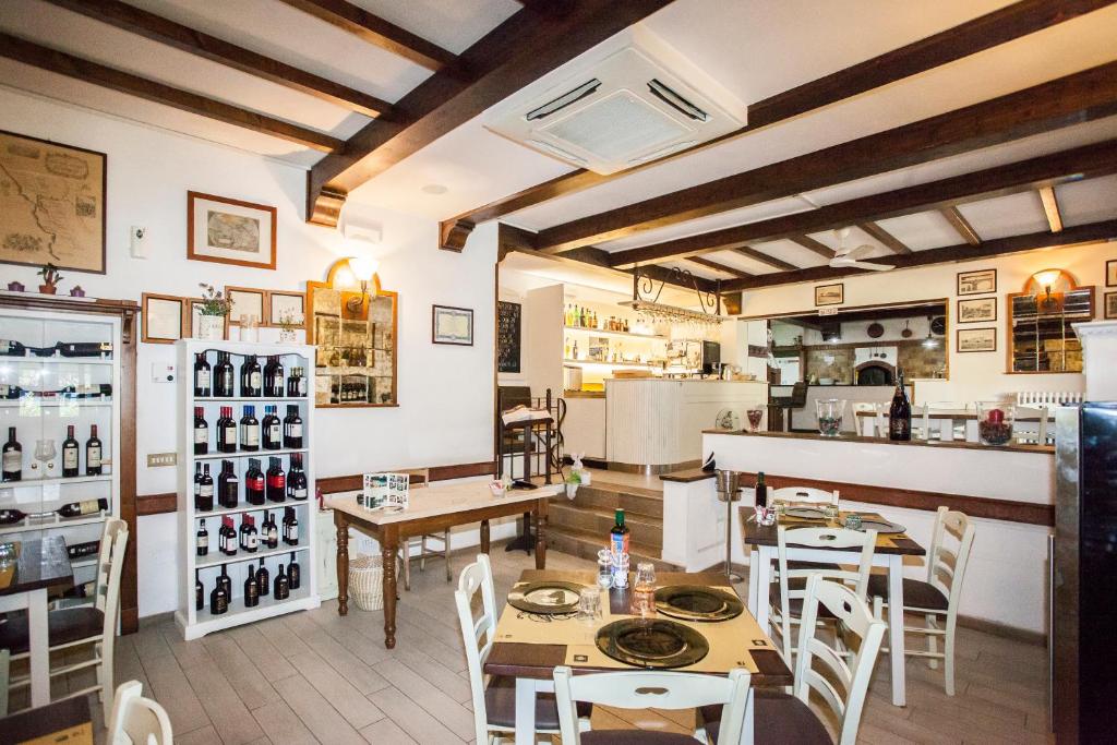 a restaurant with tables and chairs and a kitchen at Da Fiore in Cecina