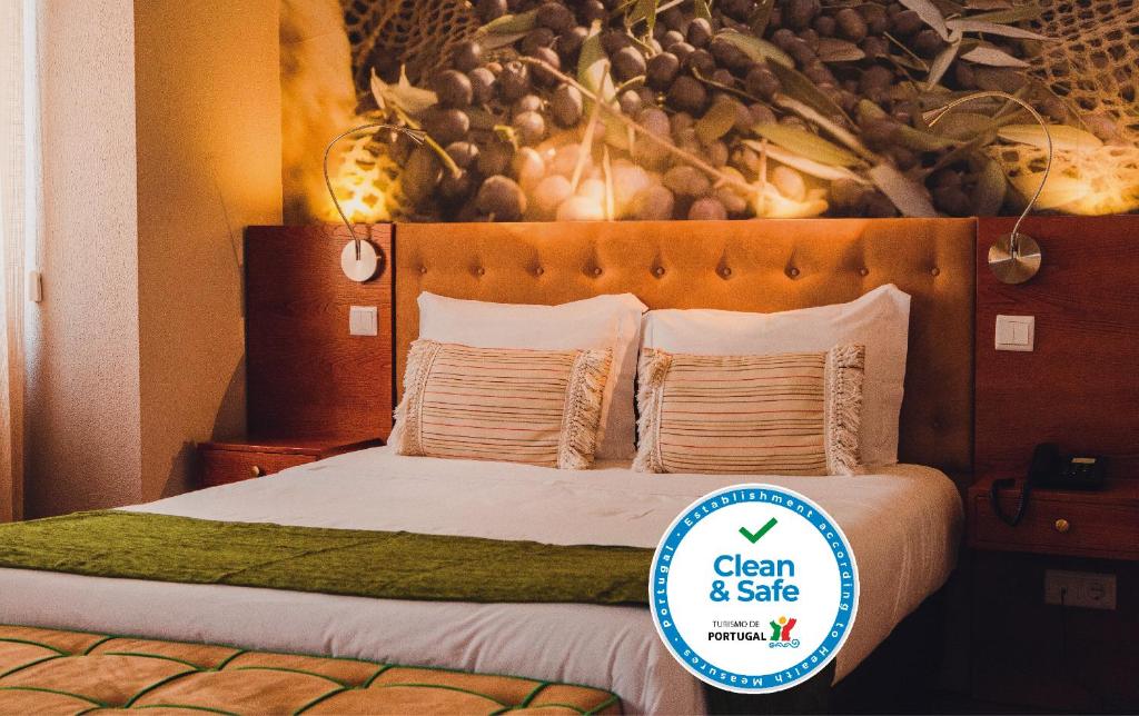 Ένα ή περισσότερα κρεβάτια σε δωμάτιο στο Hotel Império do Rei