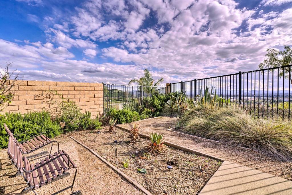 un banc installé dans un jardin à côté d'une clôture dans l'établissement Single-Story San Bernardino Home with Valley Views!, à San Bernardino