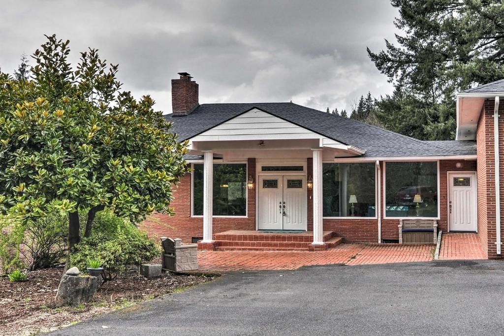 a red brick house with a white door and windows at Charming Kelso Home with Proximity to Cowlitz River! in Kelso