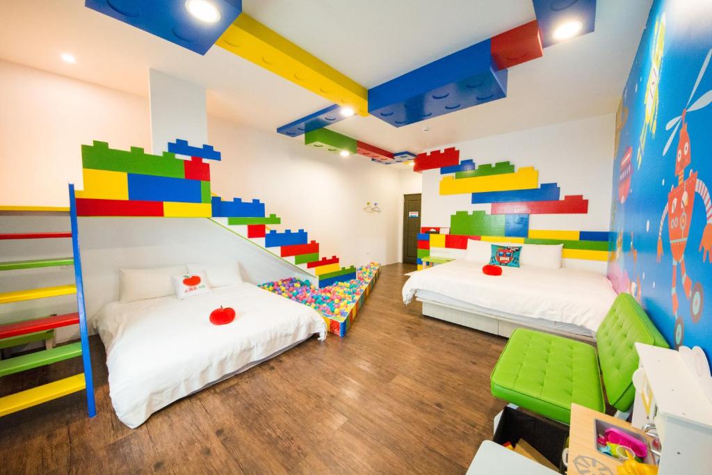 two beds in a room with a lego room at Little Apple B&B in Wujie