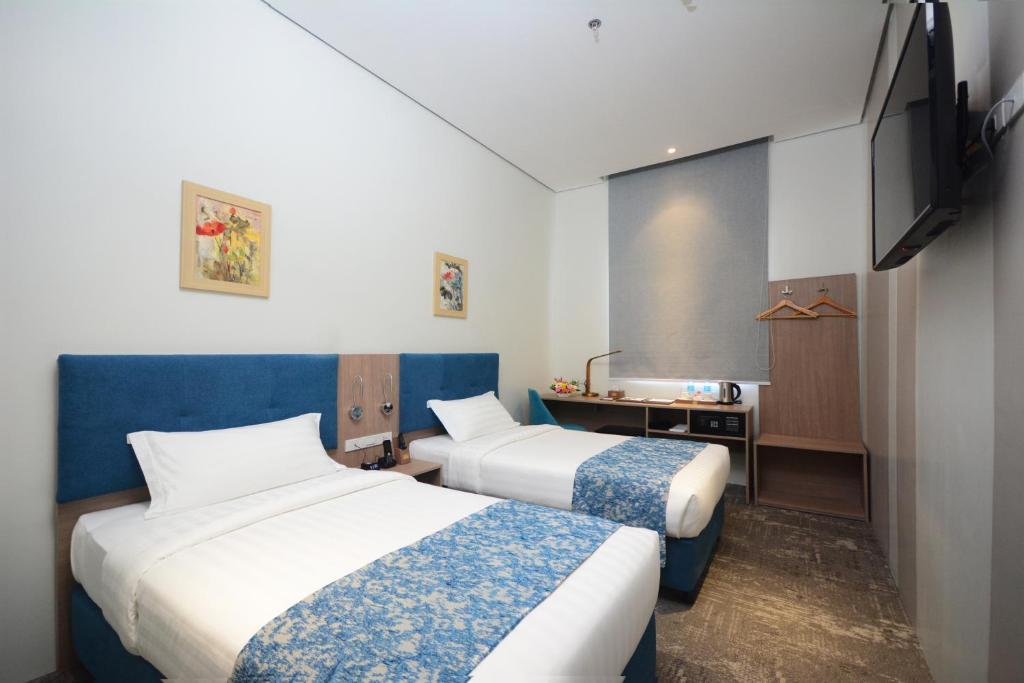 Postel nebo postele na pokoji v ubytování Blue Lotus Hotel