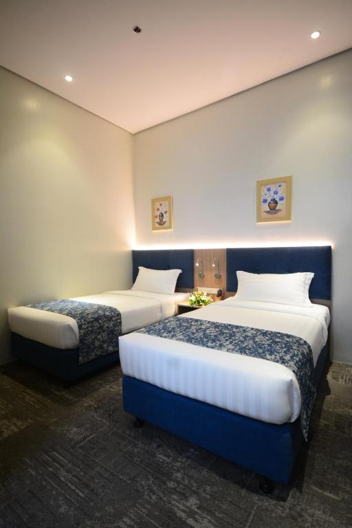 Postel nebo postele na pokoji v ubytování Blue Lotus Hotel
