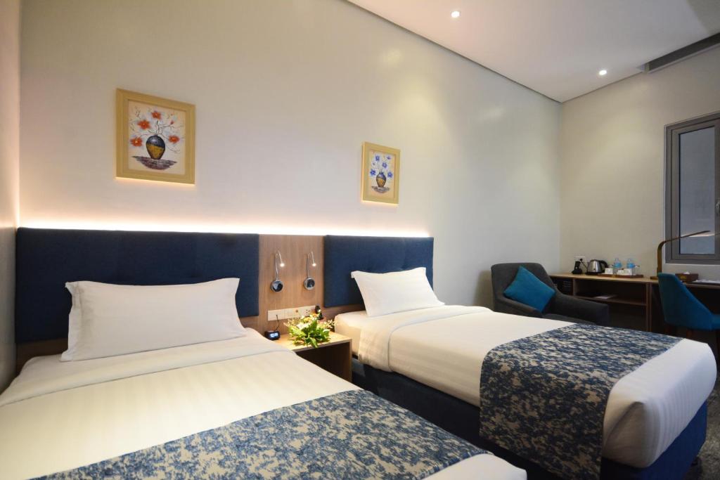 Postel nebo postele na pokoji v ubytování Blue Lotus Hotel