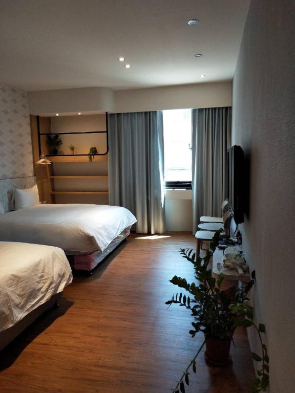 A bed or beds in a room at Light Blue Hostel