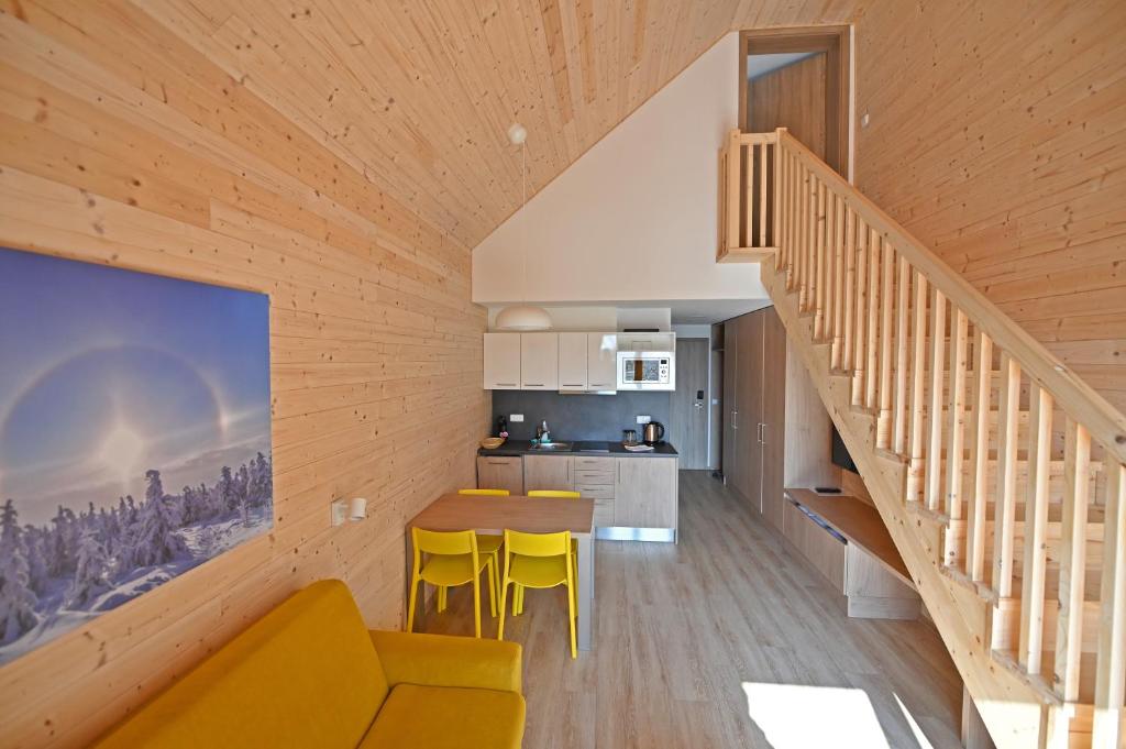 a kitchen and dining room in a wooden house at Vetrnik Depandance Hotelu Jirinka in Dolní Morava