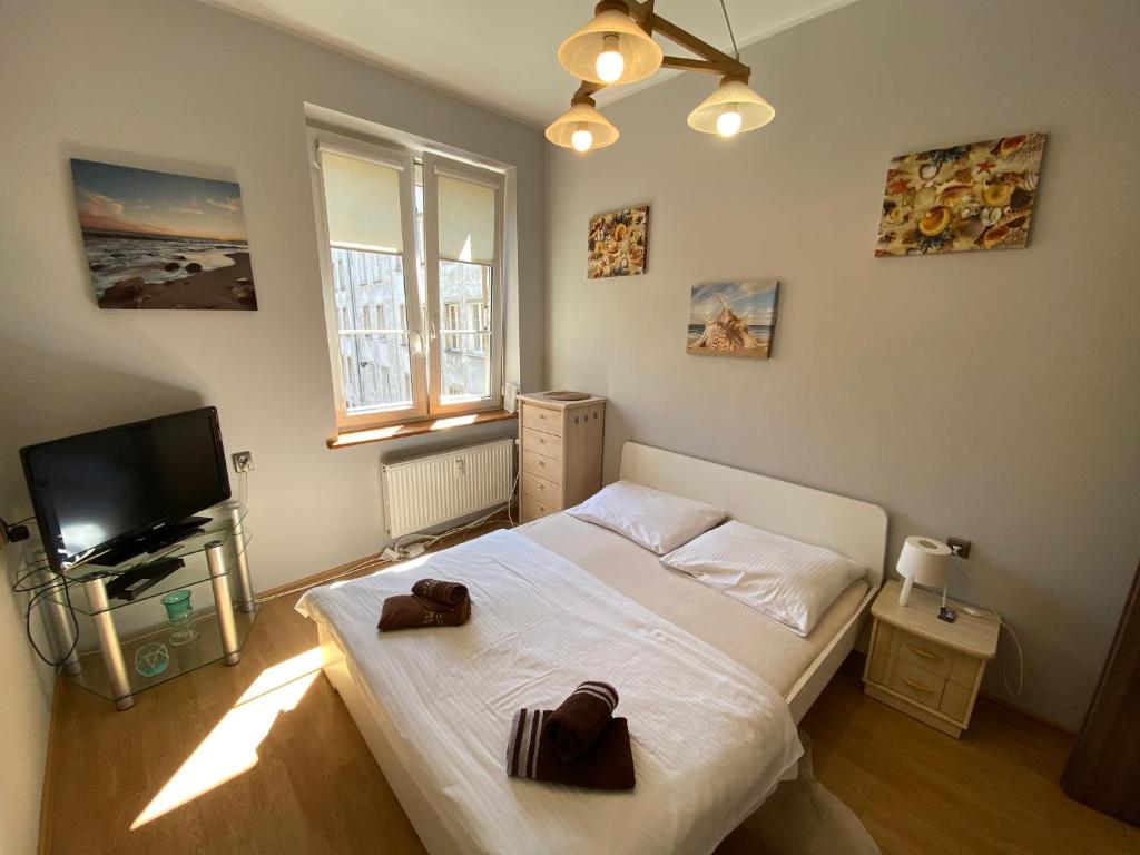 Кровать или кровати в номере Gdańskie Apartamenty - Apartamenty na Długiej i na Garbary